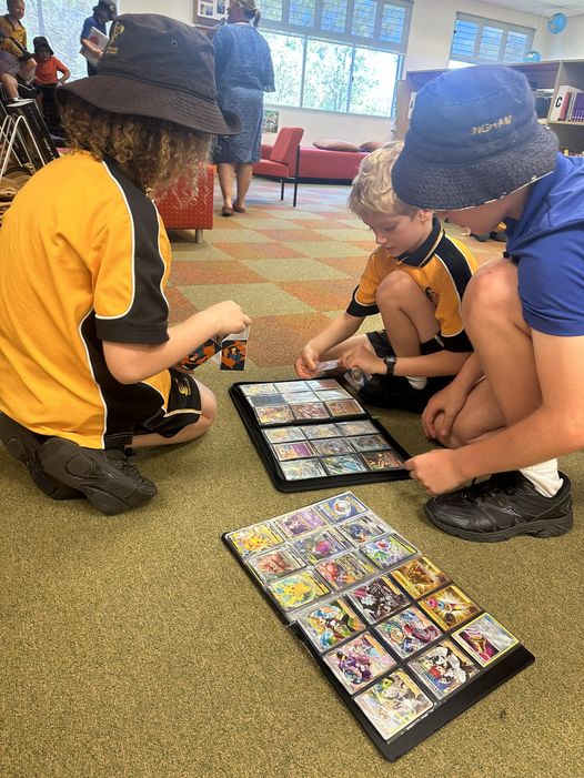 Students trading pokemon cards